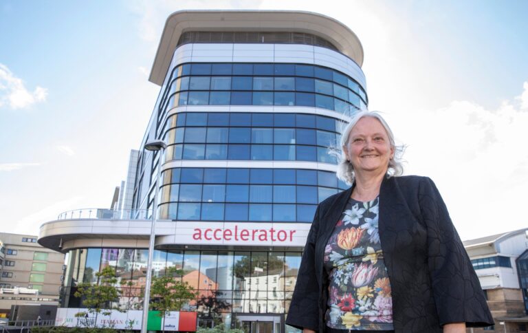 Professor Janet Hemingway standing in front of the Accelerator Building